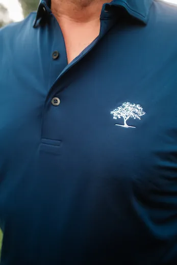 The tree on a navy polo