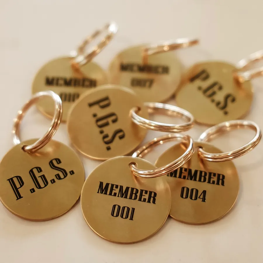 An assortment of numbered P.G.S. Membership Tags