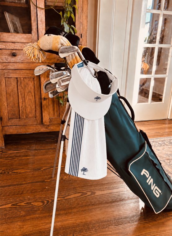 The Proper Golfer Caddie Towel draped over a vintage PING bag